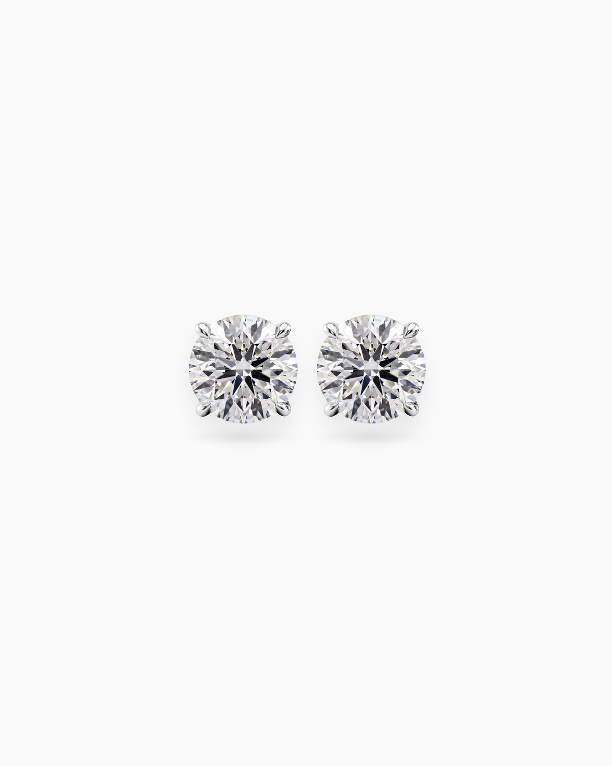 Round cut lab grown diamond stud earrings in 18K white gold, 1ct and 2ct total weight